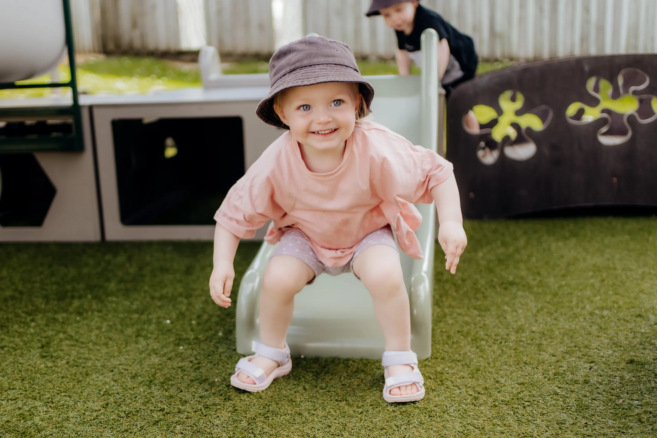 A smiling child playing outside