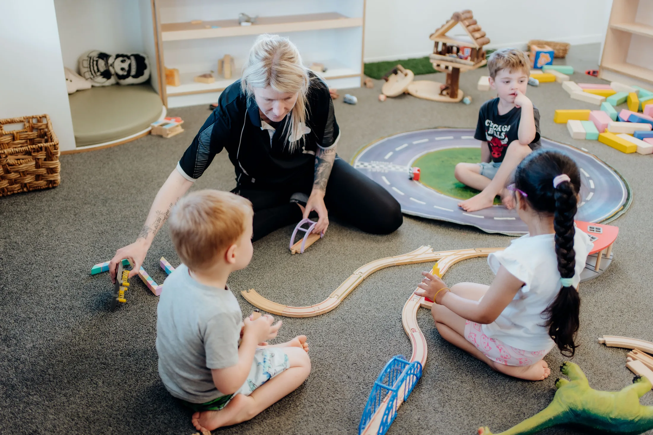 A small group of tamariki learning together with their kaiako at Tiny Legends