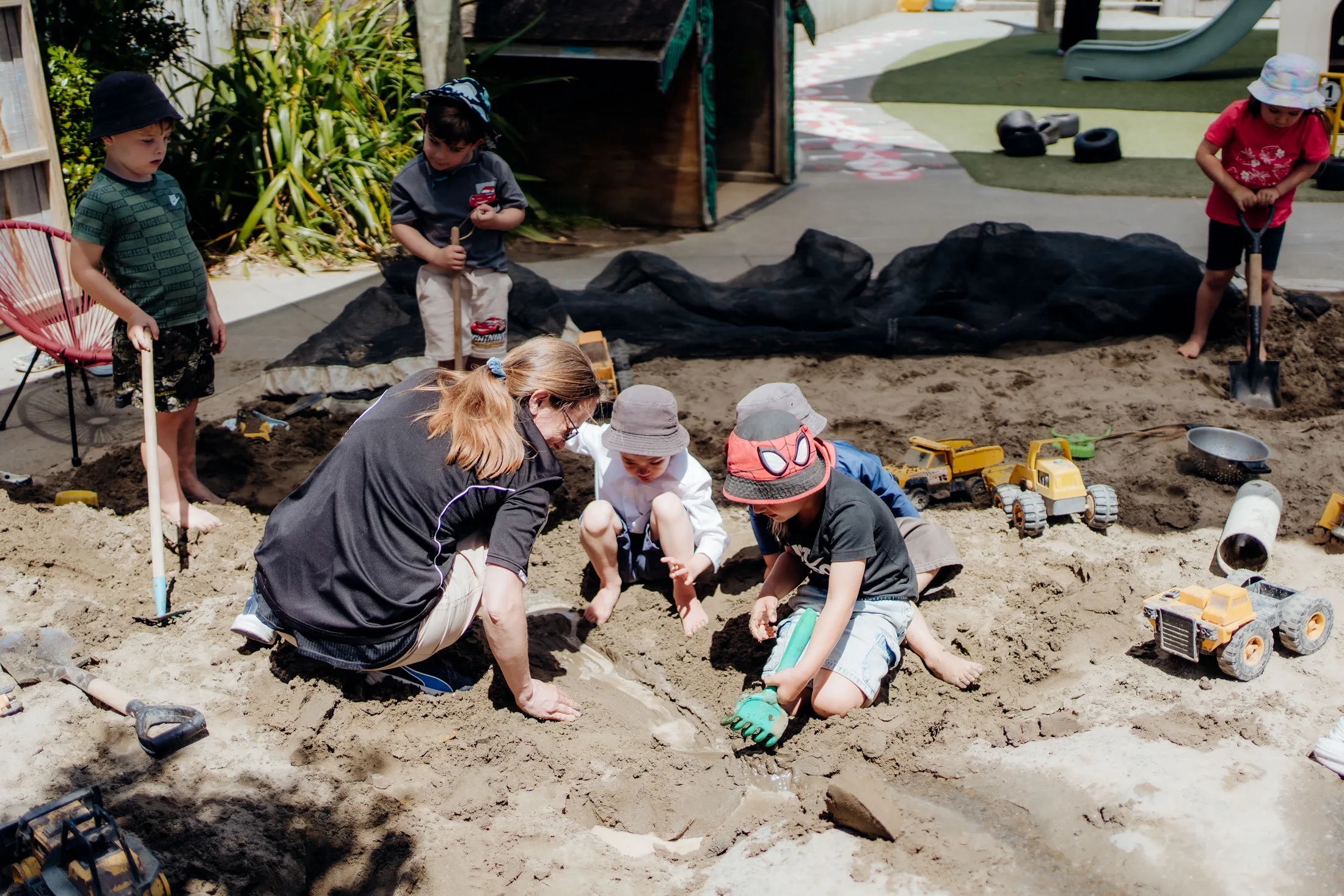 Busy hands and teamwork in the sandpit